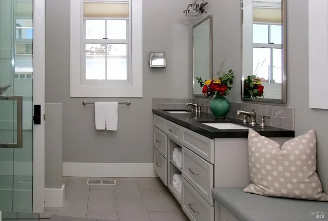 a kitchen with stainless steel appliances kitchen island granite countertop a sink and a white cabinets