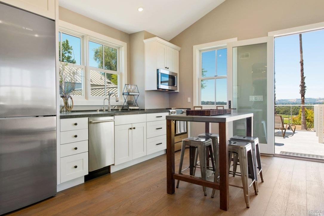 1531 Estee Avenue Napa, CA 94558 - Photo 29 of 49 a kitchen with a table chairs refrigerator and cabinets