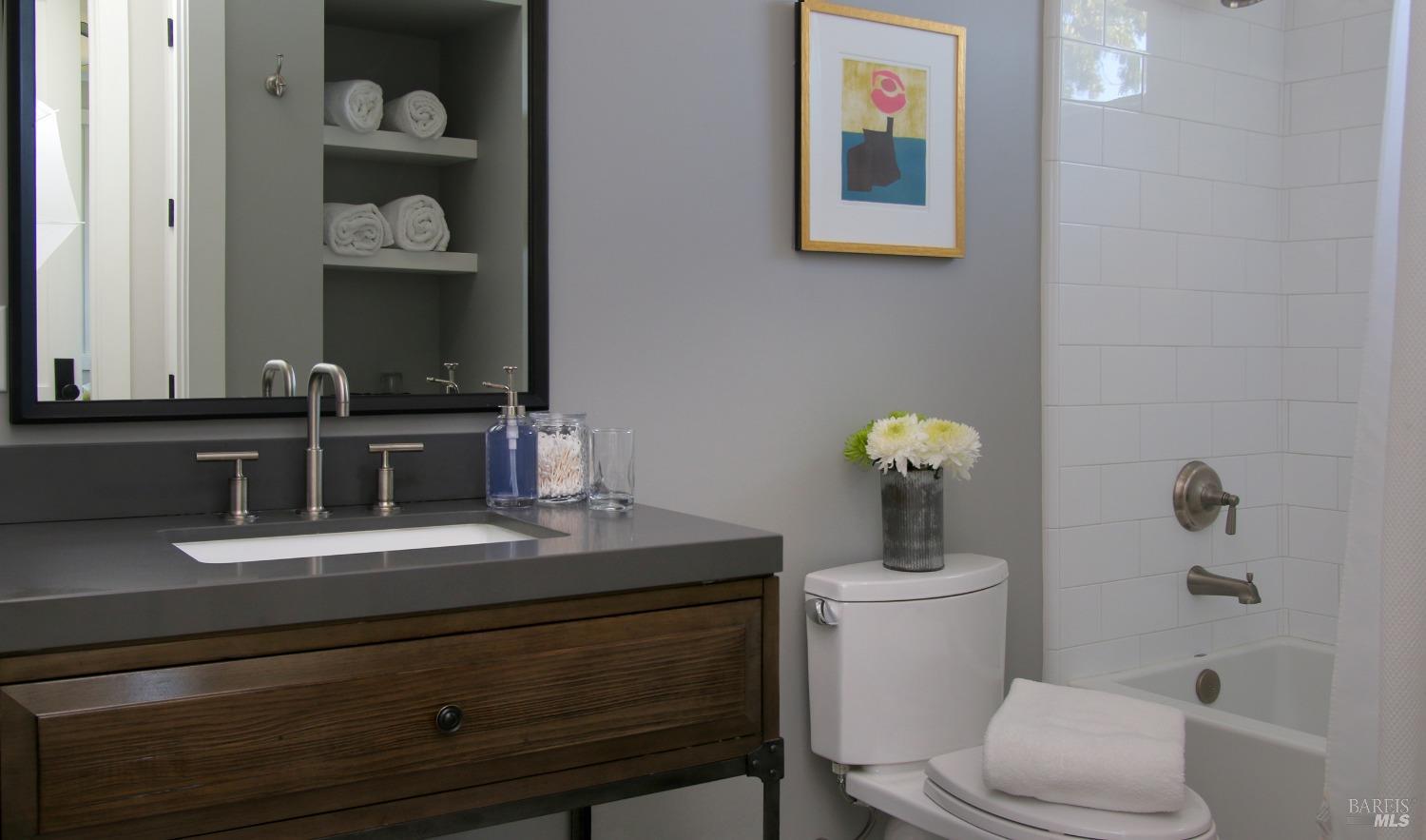 1531 Estee Avenue Napa, CA 94558 - Photo 35 of 49 a bathroom with a toilet a sink and mirror