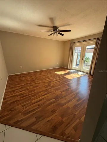 a view of an empty room with a window and fireplace