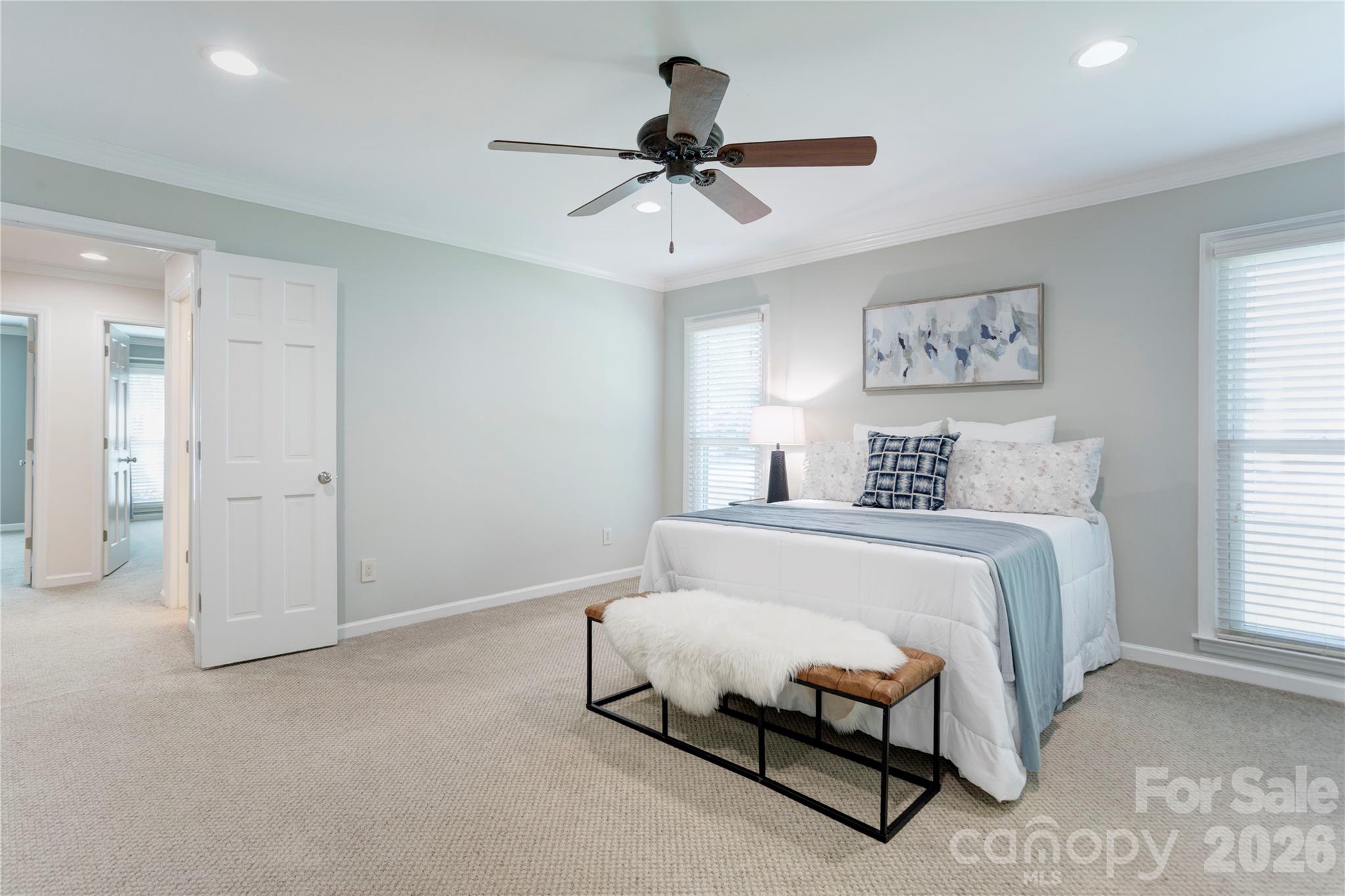 1188 Fawn Ridge Road Northwest Concord, NC 28027 - Photo 21 of 38 a bedroom with a bed and a chandelier