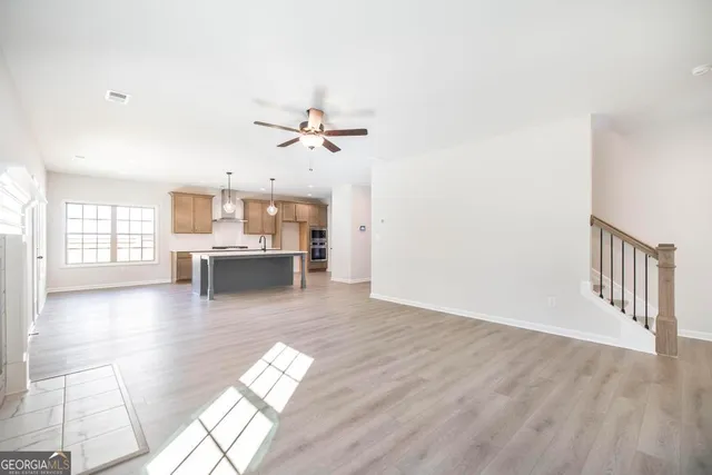 a view of a living room with kitchen furniture and a kitchen view