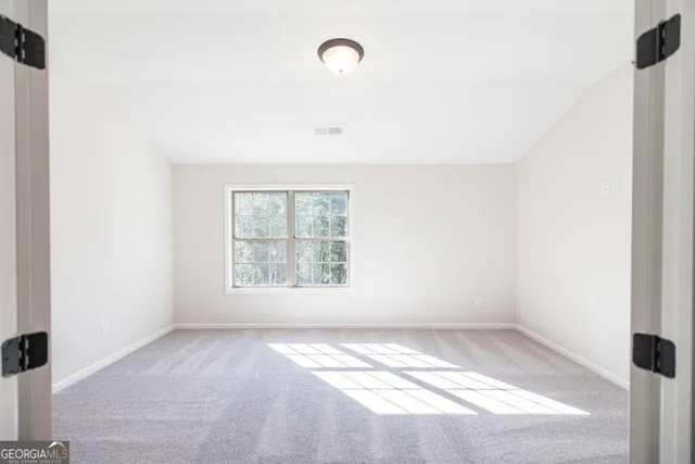 a view of room with window and ceiling fan