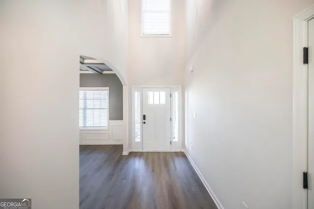 a view of wooden floor and windows in a room