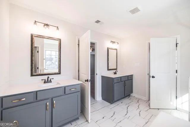 a bathroom with a sink vanity and mirror
