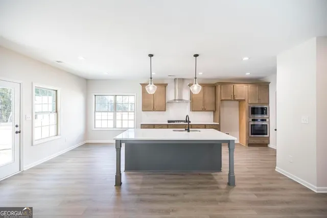 a large kitchen with a table and chairs