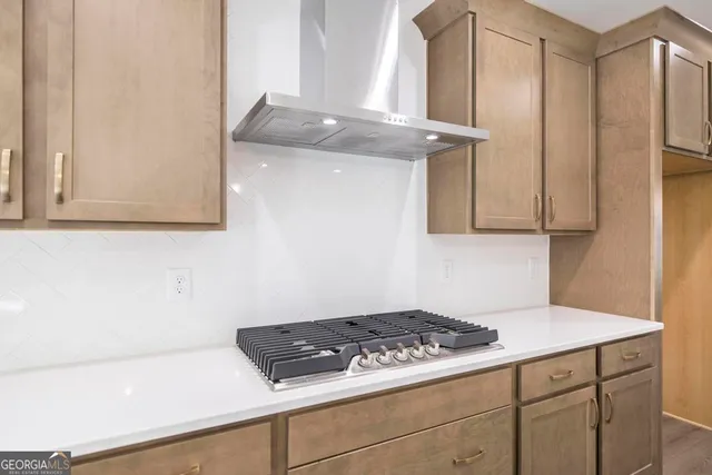 a stove top oven sitting inside of a kitchen