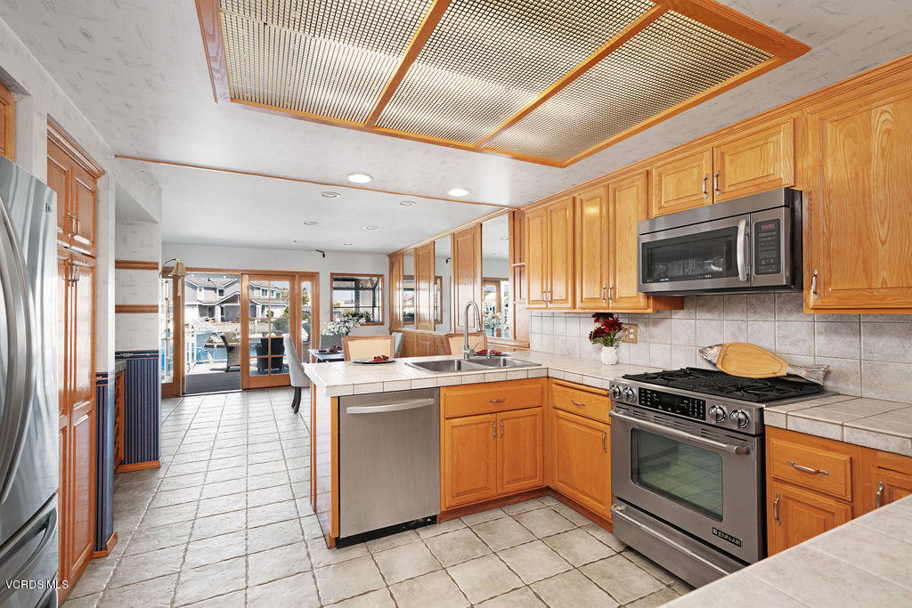 2260 Harbor Boulevard Oxnard, CA 93035 - Photo 15 of 28 a kitchen with stainless steel appliances granite countertop a stove sink and microwave