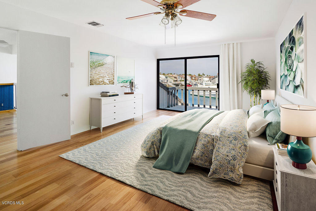 2260 Harbor Boulevard Oxnard, CA 93035 - Photo 16 of 28 a spacious bedroom with a large bed and a chandelier