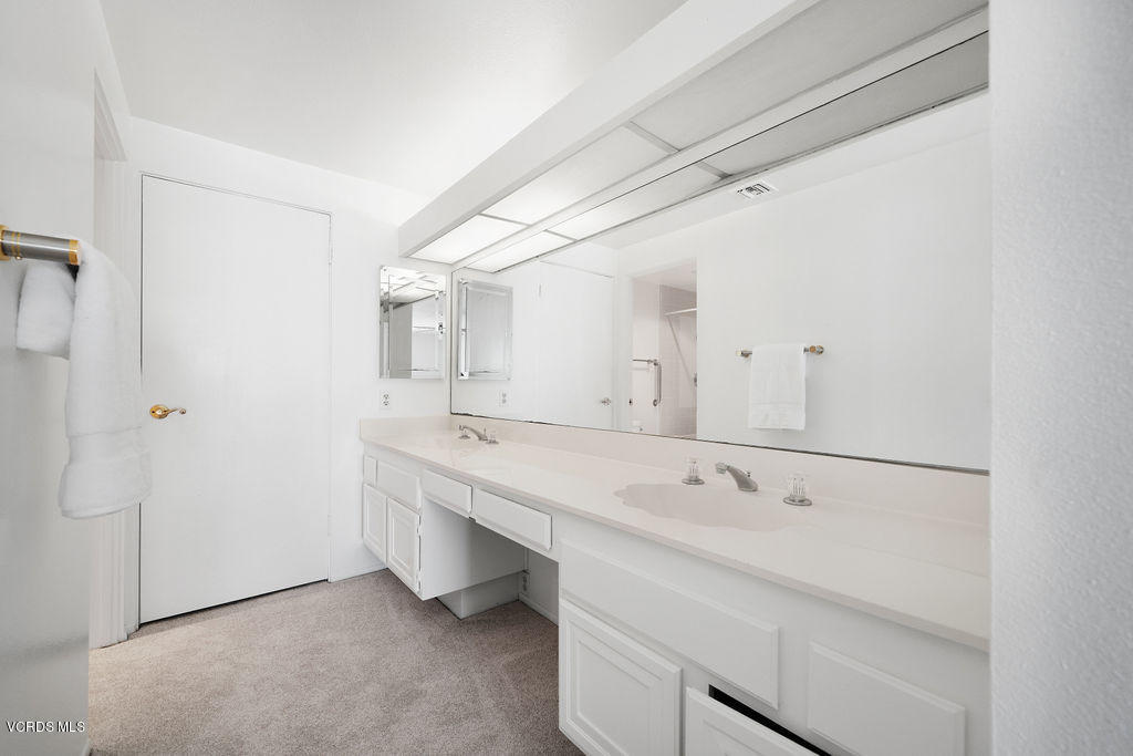 2260 Harbor Boulevard Oxnard, CA 93035 - Photo 22 of 28 a bathroom with a double vanity sink and mirror