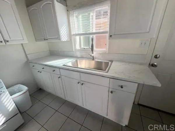 a kitchen with a sink cabinets and window