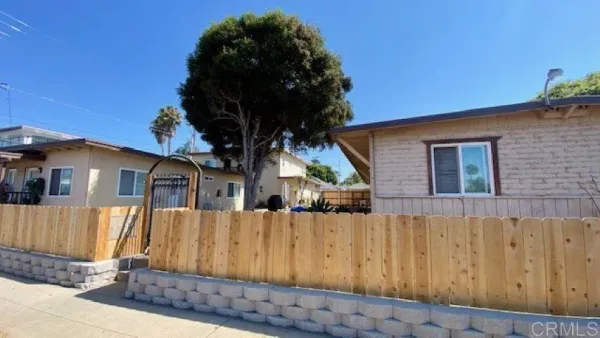 a view of a house with wooden fence
