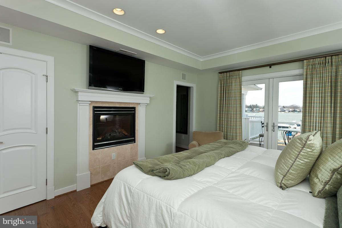 1712 Wilson Point Road Baltimore, MD 21220 - Photo 17 of 30 a bedroom with a bed and a television