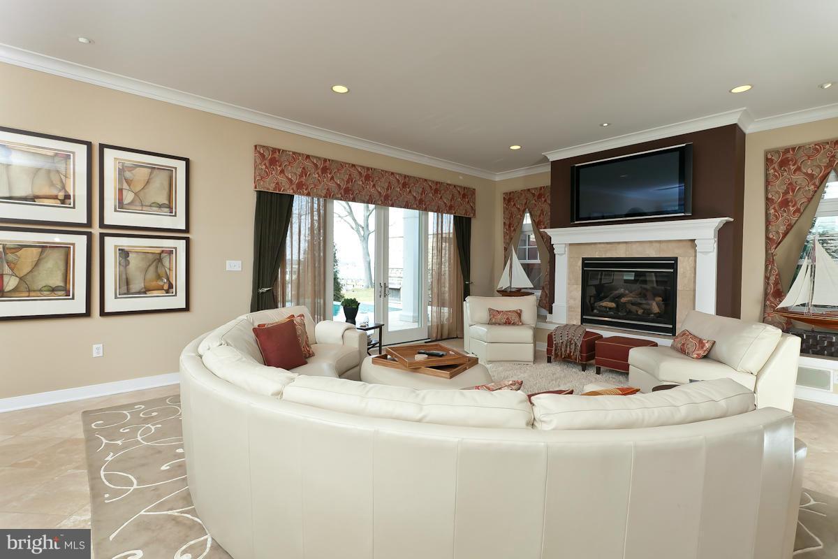 1712 Wilson Point Road Baltimore, MD 21220 - Photo 6 of 30 a living room with fireplace furniture and a flat screen tv