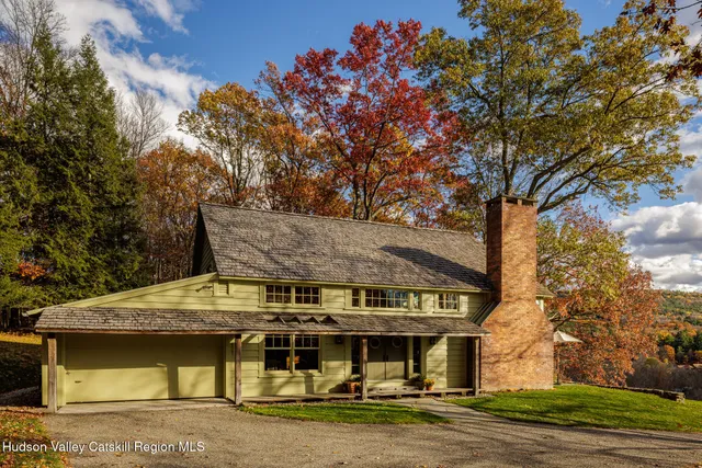a outdoor living room with fireplace furniture and a floor to ceiling window