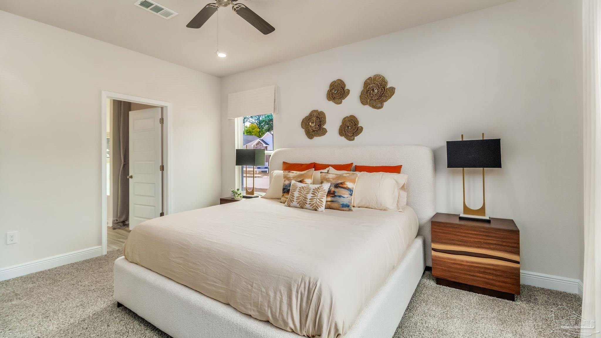 8717 Bluebell Street Milton, FL 32583 - Photo 14 of 30 a bedroom with a bed and a chandelier