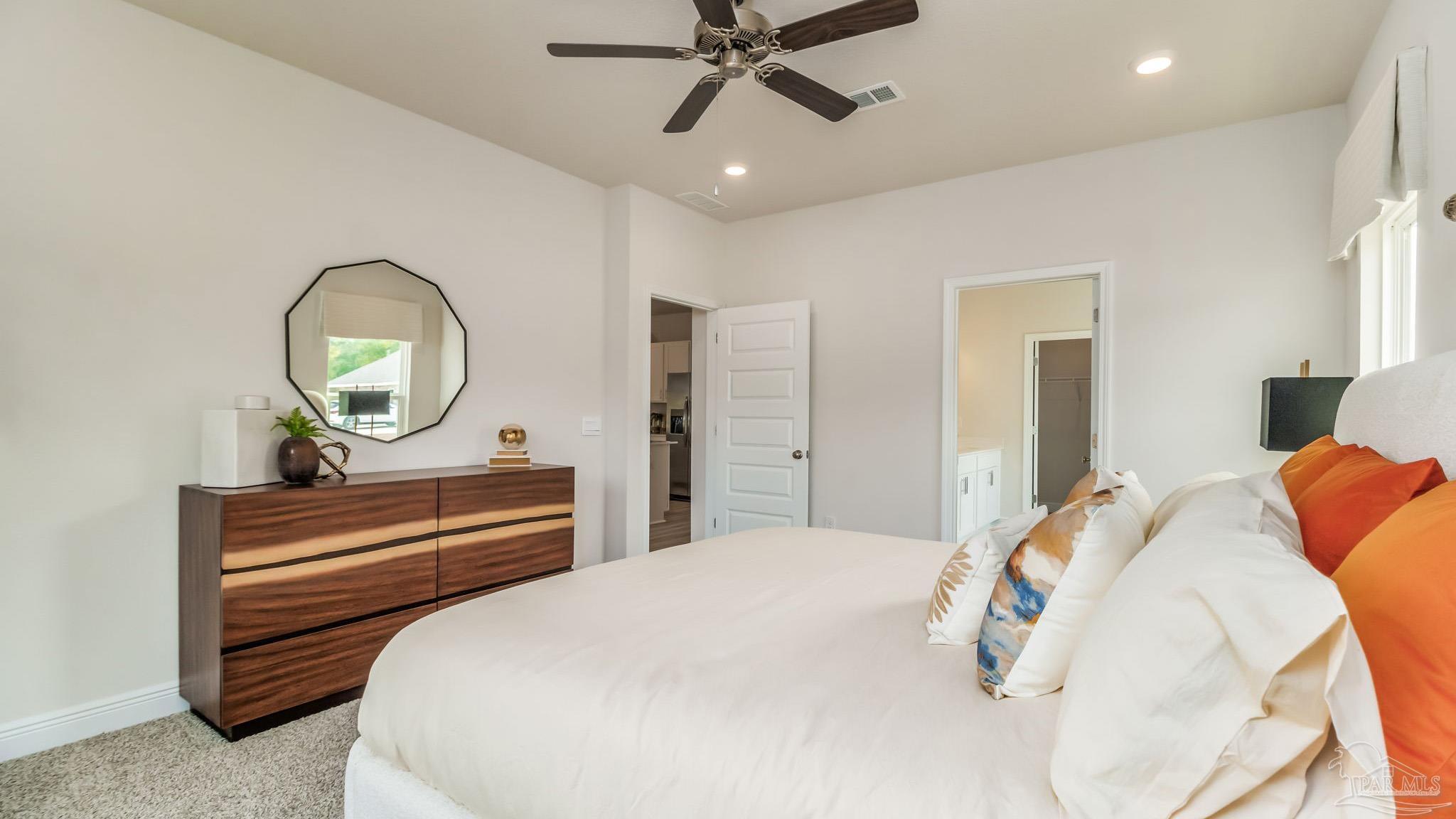 8717 Bluebell Street Milton, FL 32583 - Photo 15 of 30 a bedroom with a bed and a chandelier
