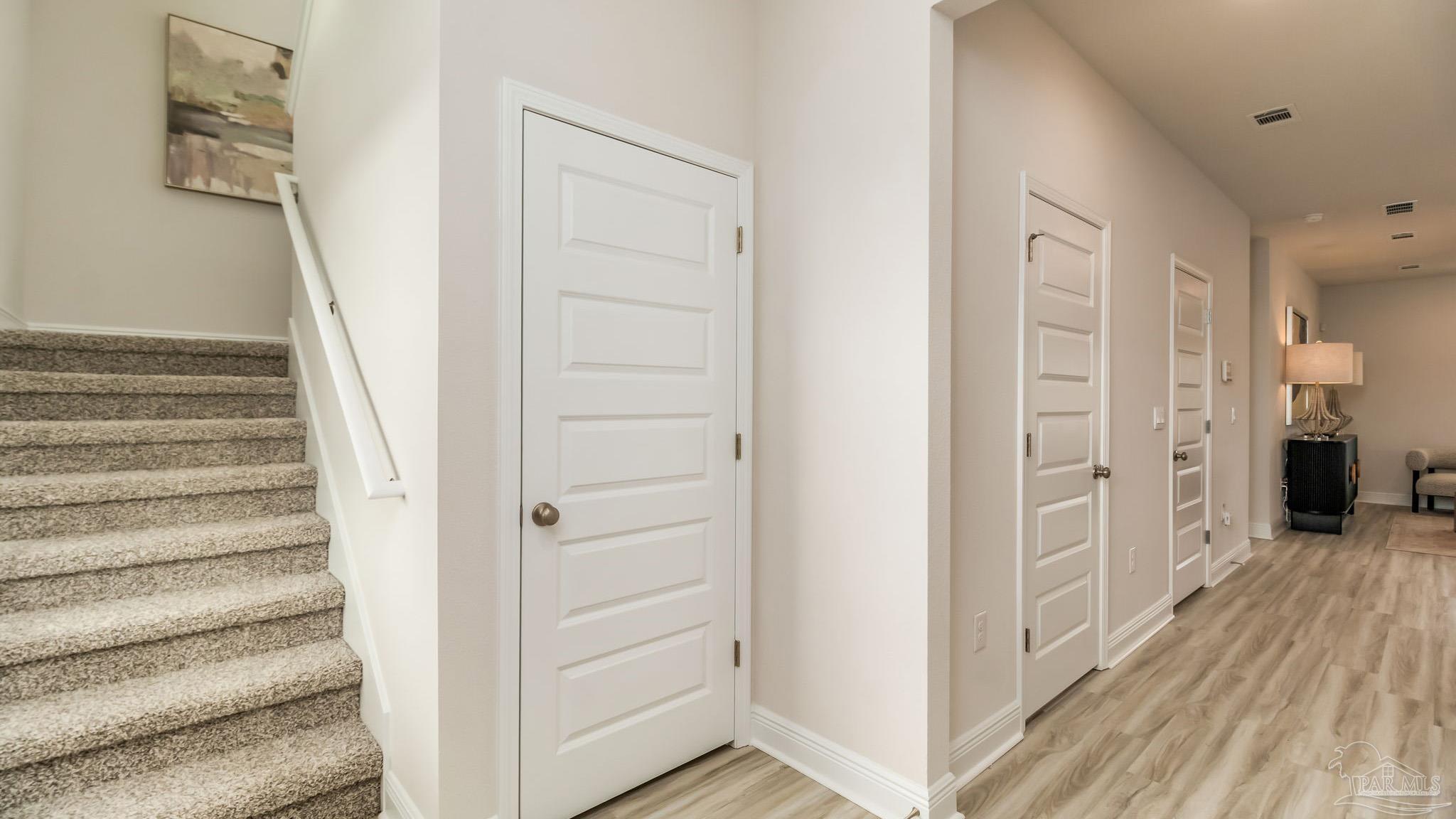 8717 Bluebell Street Milton, FL 32583 - Photo 19 of 30 a view of a hallway with wooden floor and entryway