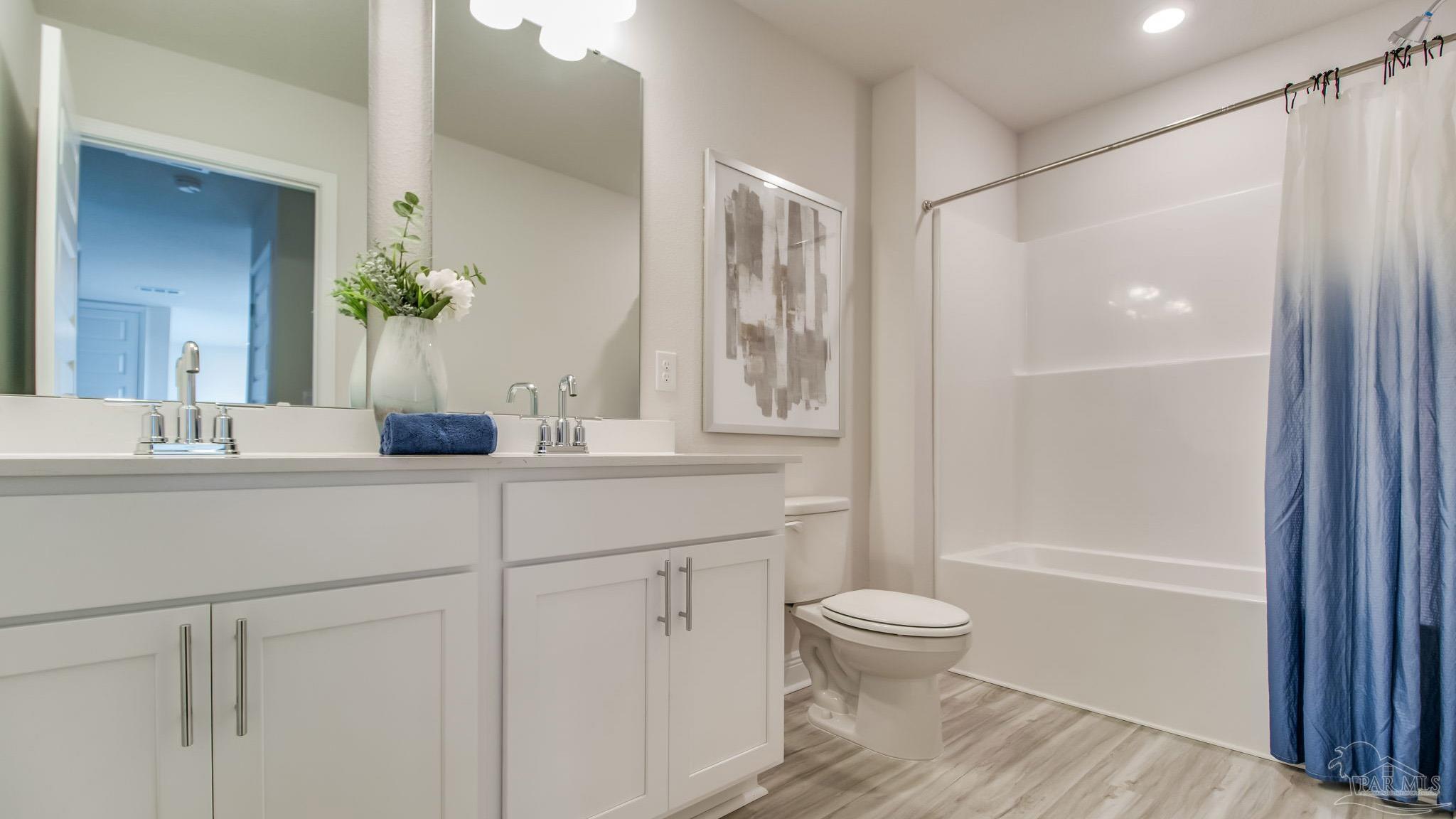 8717 Bluebell Street Milton, FL 32583 - Photo 24 of 30 a bathroom with a sink a toilet and shower