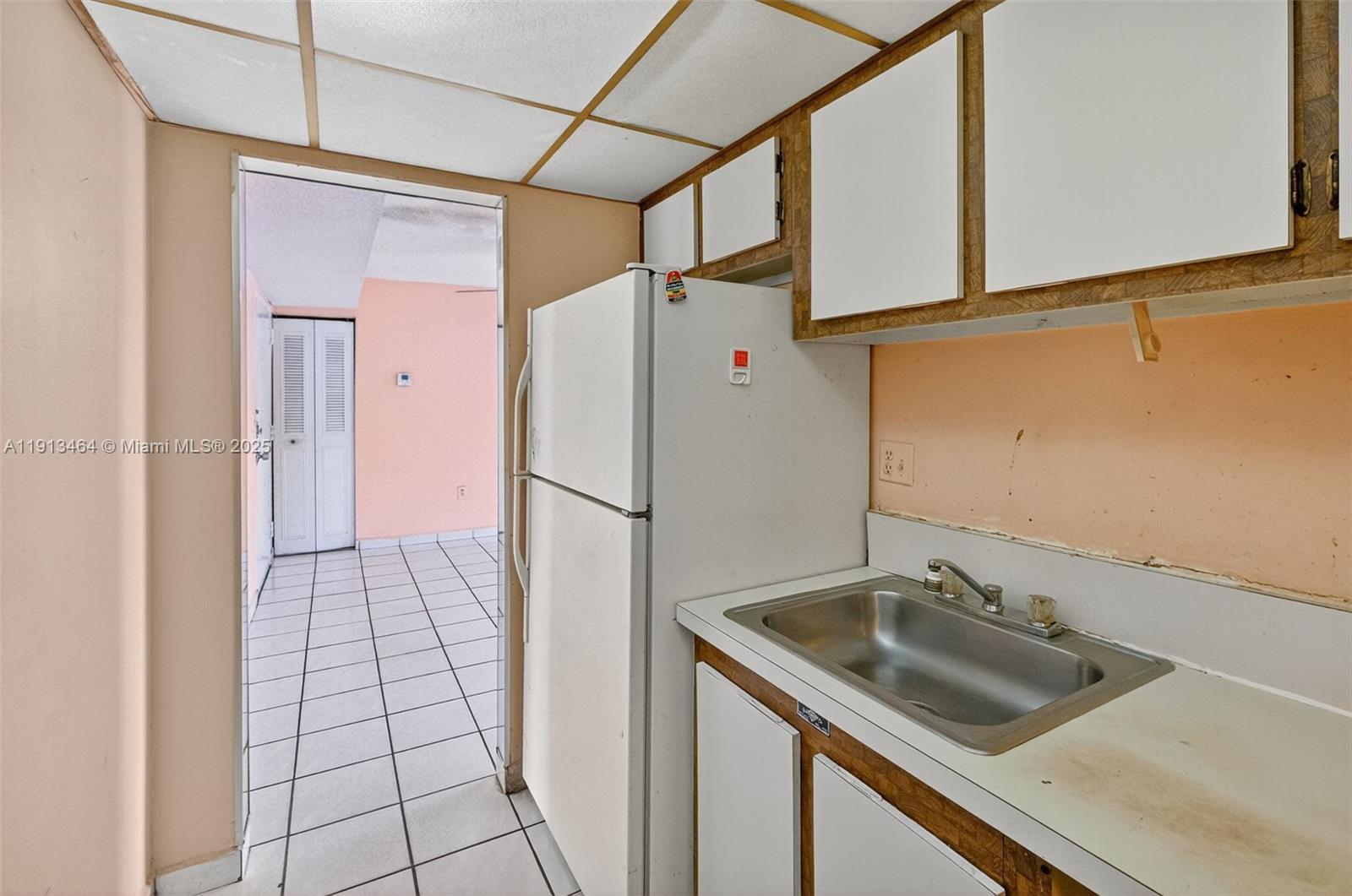 4841 Northwest 7th Street, Unit 3094 Miami, FL 33126 - Photo 11 of 33 a kitchen with a sink a counter top space and stainless steel appliances