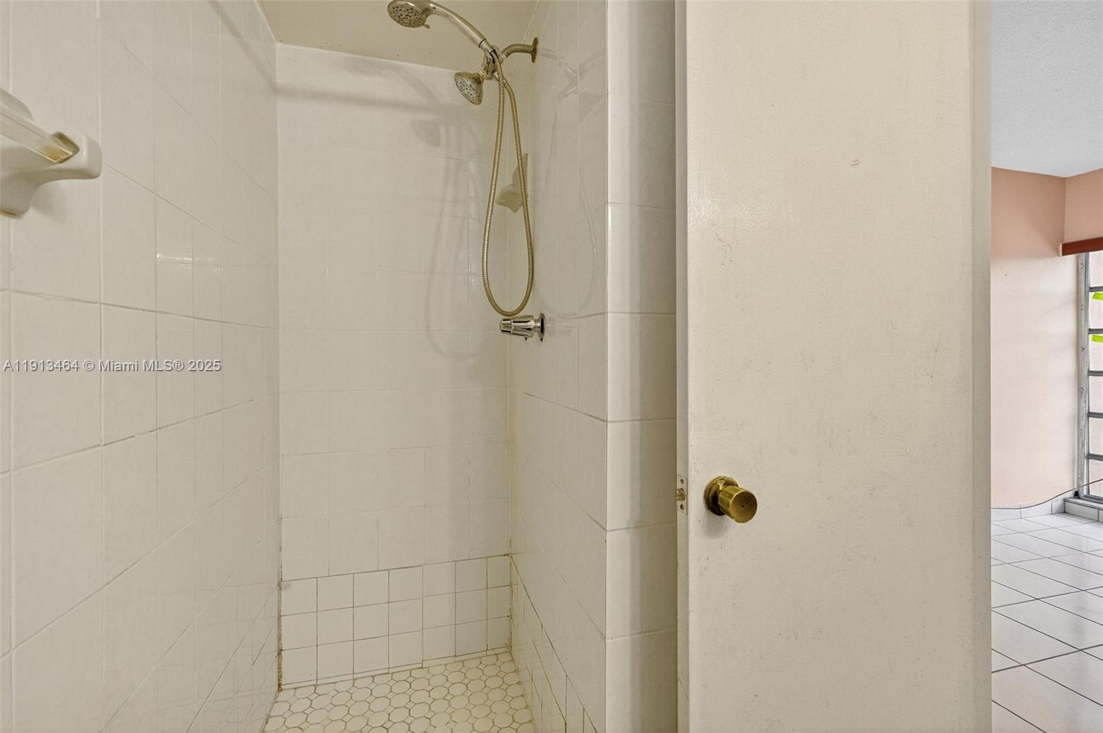 4841 Northwest 7th Street, Unit 3094 Miami, FL 33126 - Photo 25 of 33 a bathroom with a shower