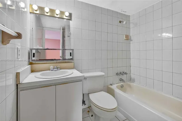 a bathroom with a sink toilet vanity and bathtub