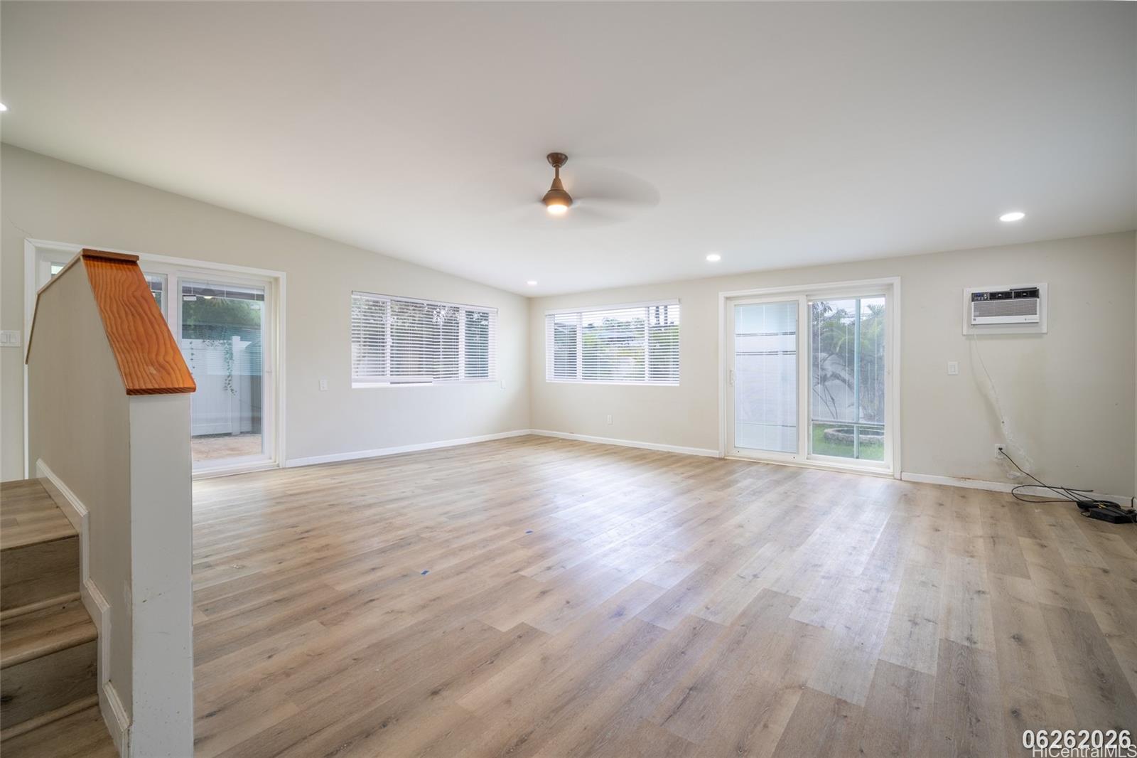 87-1409 Akowai Road Waianae, HI 96792 - Photo 22 of 25 a view of an empty room with wooden floor and a window