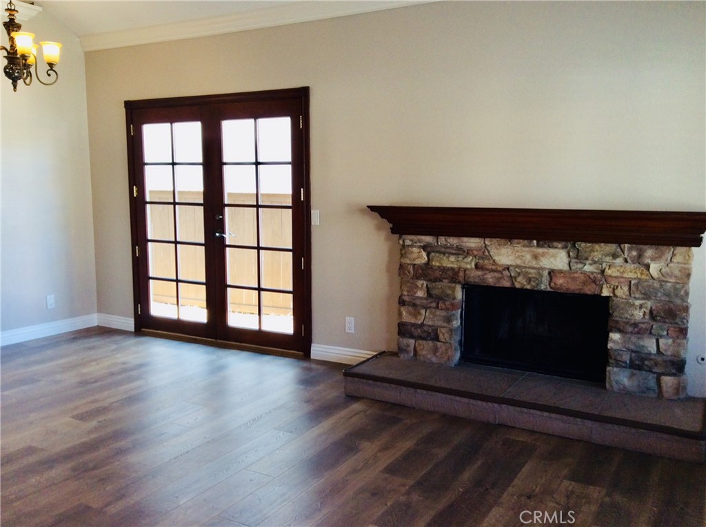 7 Mejorana Rancho Santa Margarita, CA 92688 - Photo 16 of 44 an empty room with wooden floor fireplace and windows