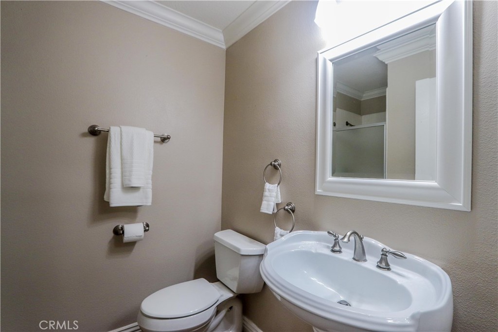 7 Mejorana Rancho Santa Margarita, CA 92688 - Photo 27 of 44 a bathroom with a toilet a sink and mirror
