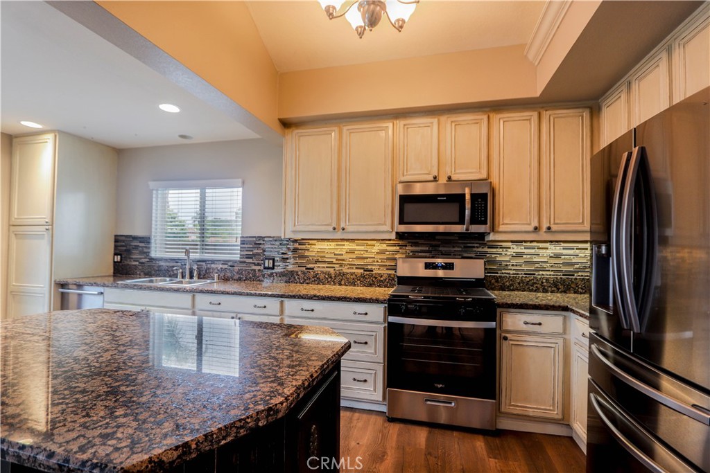 7 Mejorana Rancho Santa Margarita, CA 92688 - Photo 4 of 44 a kitchen with kitchen island granite countertop a stove sink and microwave