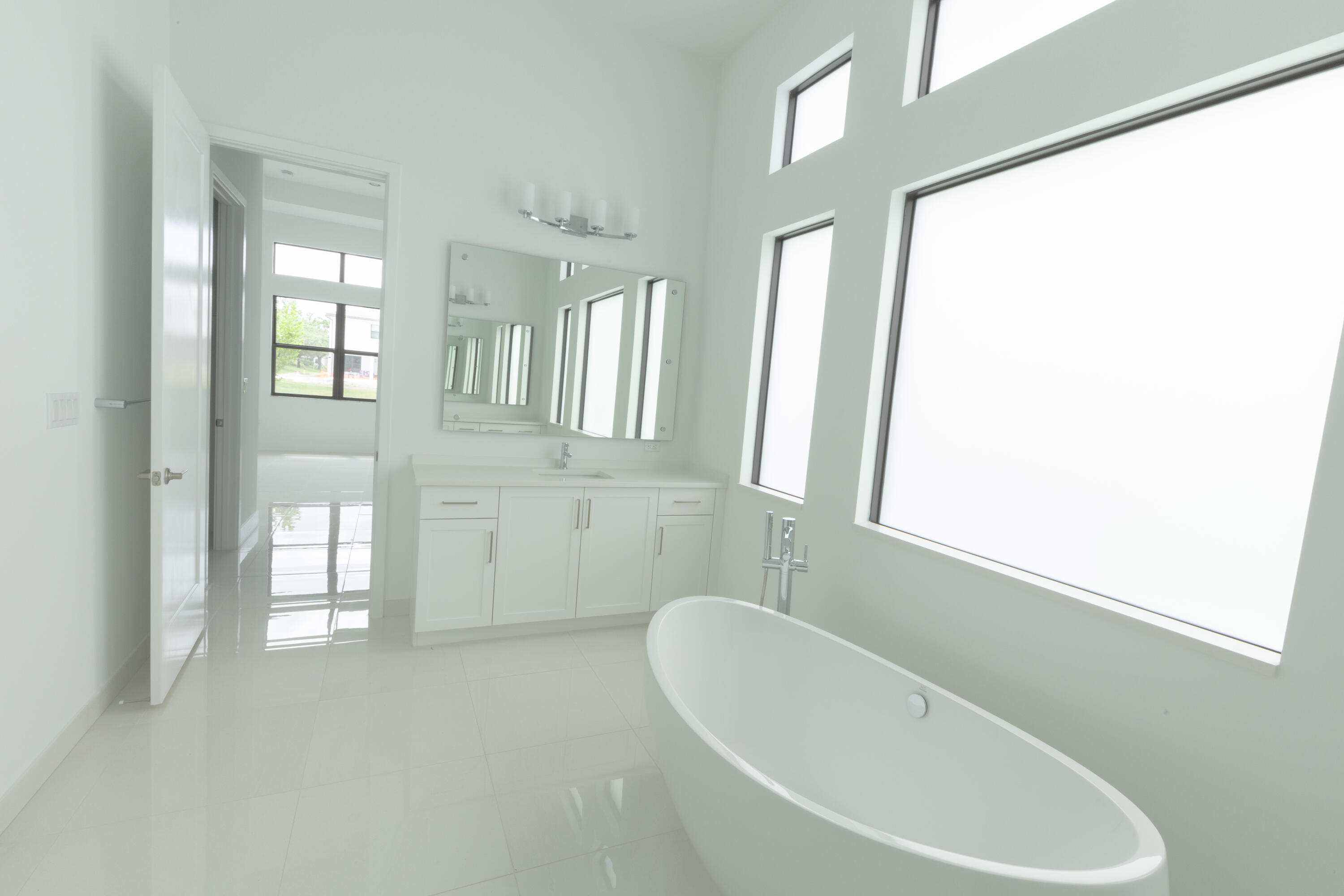 8252 Crystal Downs Avenue Boca Raton, FL 33434 - Photo 39 of 49 a white bath tub sitting in a bathroom next to a window