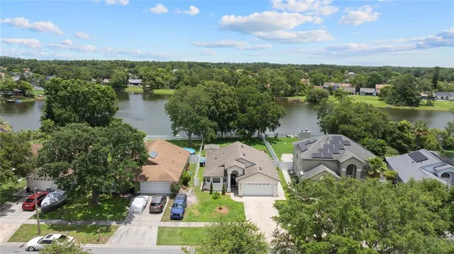 an aerial view of a house with a lake view