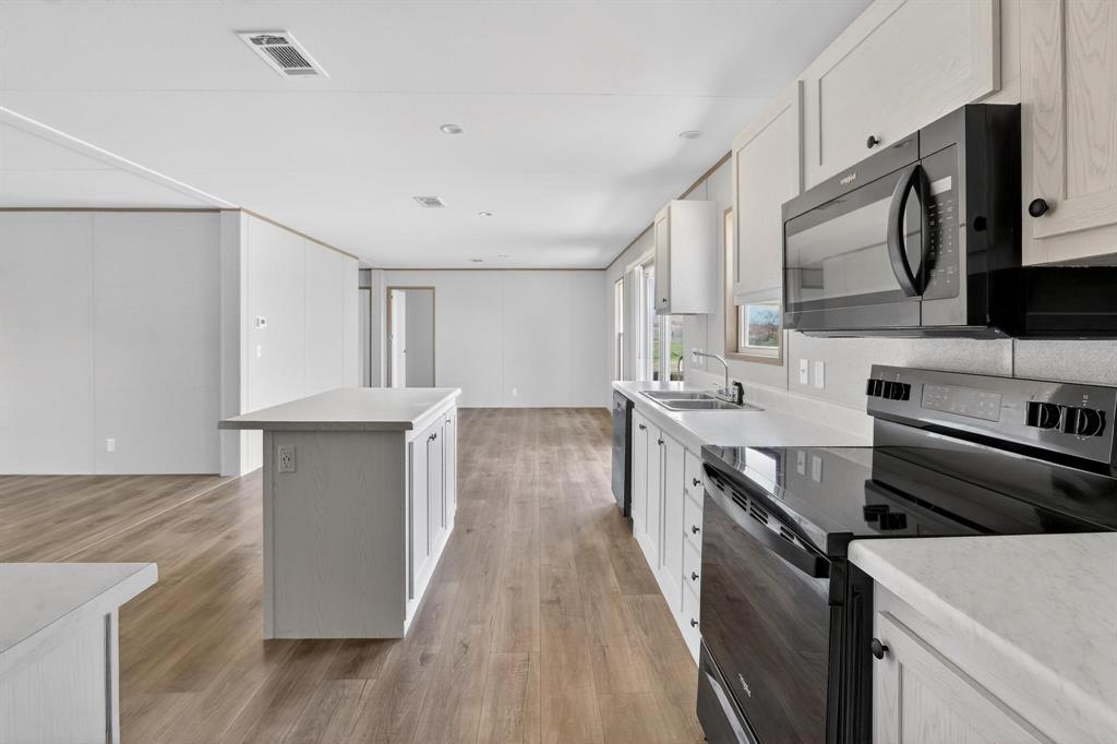 206 Rhett Court Aurora, TX 76078 - Photo 13 of 40 a kitchen with a stove sink and a microwave