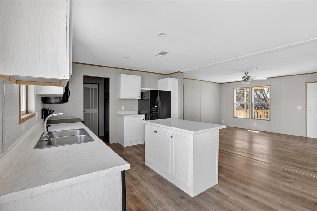 206 Rhett Court Aurora, TX 76078 - Photo 14 of 40 a kitchen with stainless steel appliances a refrigerator and a stove top oven