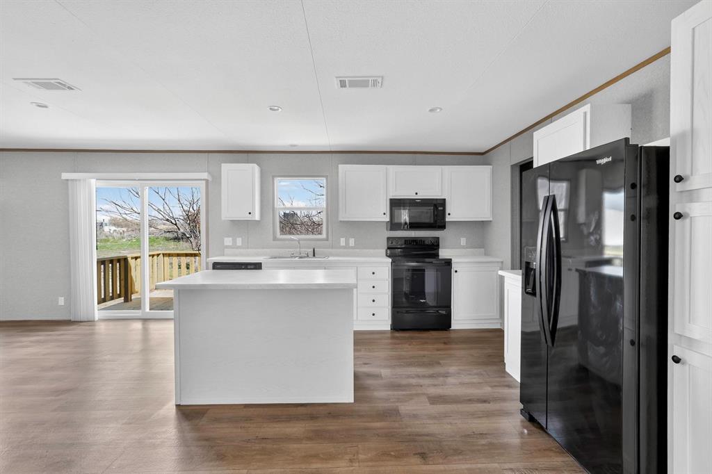 206 Rhett Court Aurora, TX 76078 - Photo 16 of 40 a kitchen with a refrigerator and a sink