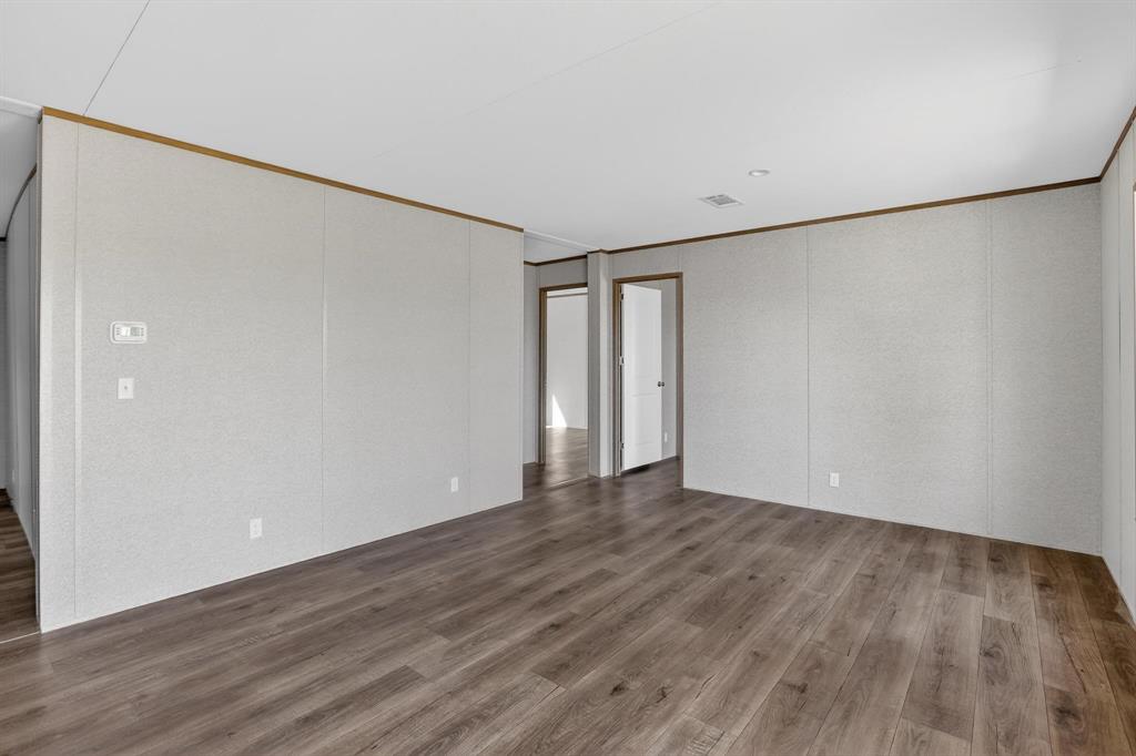 206 Rhett Court Aurora, TX 76078 - Photo 17 of 40 a view of an empty room with wooden floor