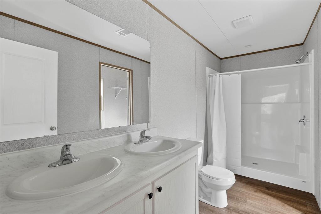 206 Rhett Court Aurora, TX 76078 - Photo 21 of 40 a bathroom with a sink and a mirror