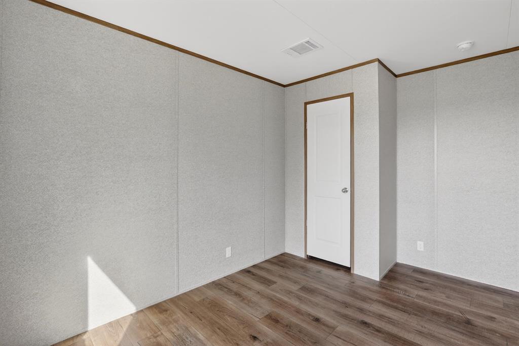 206 Rhett Court Aurora, TX 76078 - Photo 27 of 40 a view of an empty room with wooden floor