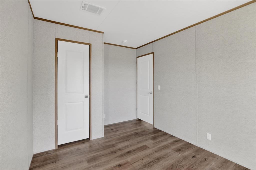 206 Rhett Court Aurora, TX 76078 - Photo 28 of 40 a view of an empty room with wooden floor and closet