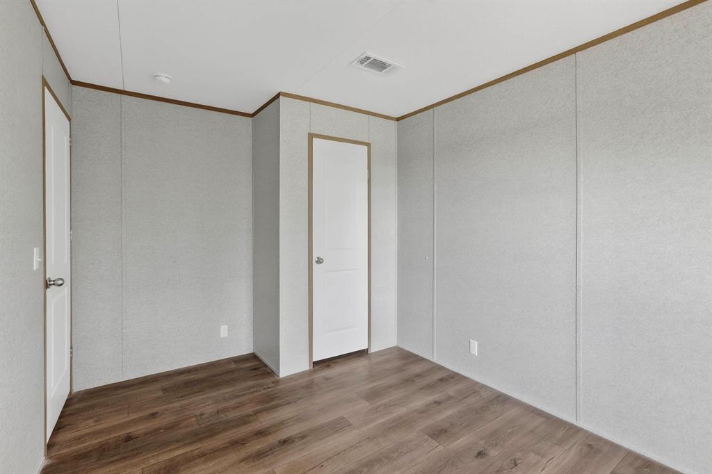 206 Rhett Court Aurora, TX 76078 - Photo 29 of 40 a view of an empty room with wooden floor