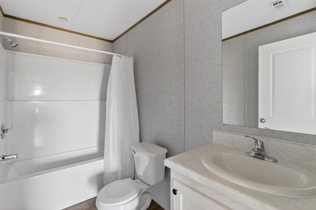 206 Rhett Court Aurora, TX 76078 - Photo 32 of 40 a bathroom with a sink toilet and shower