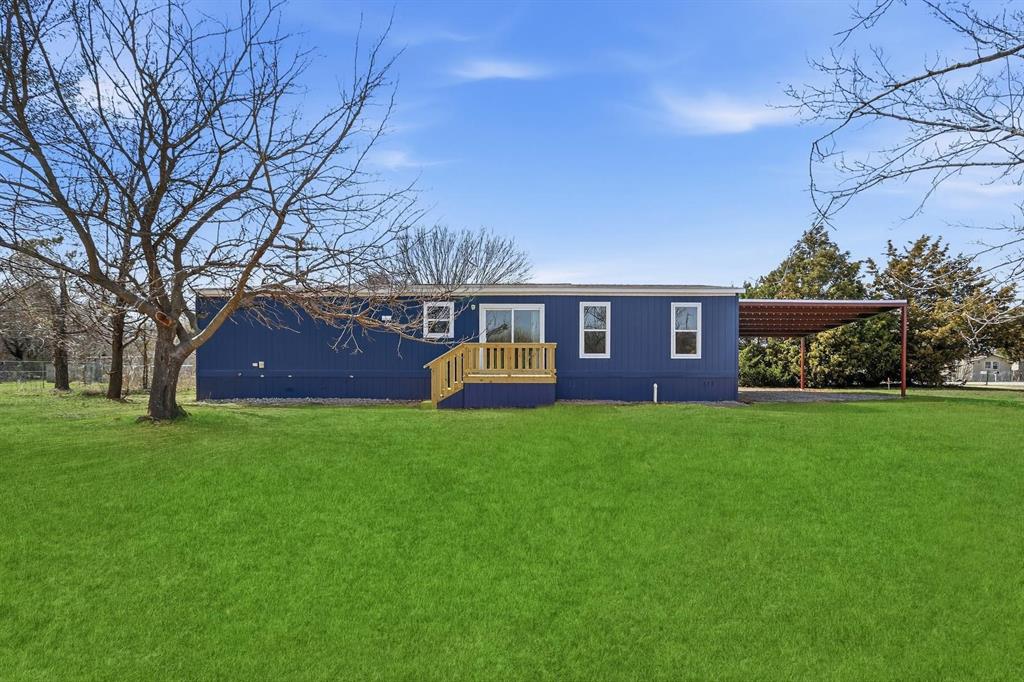 206 Rhett Court Aurora, TX 76078 - Photo 35 of 40 a front view of a house with a garden