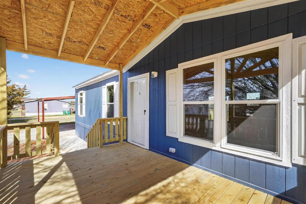 206 Rhett Court Aurora, TX 76078 - Photo 4 of 40 a view of a porch with furniture and floor to ceiling window