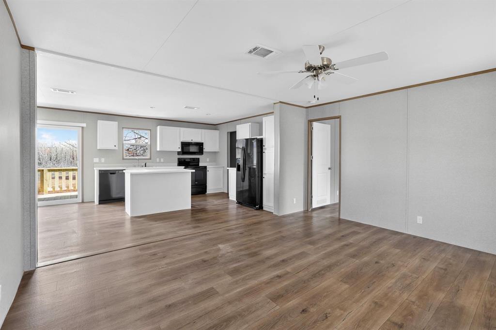 206 Rhett Court Aurora, TX 76078 - Photo 9 of 40 a view of kitchen with stainless steel appliances granite countertop cabinets and wooden floor