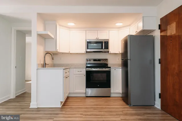 a kitchen with a refrigerator stove and sink