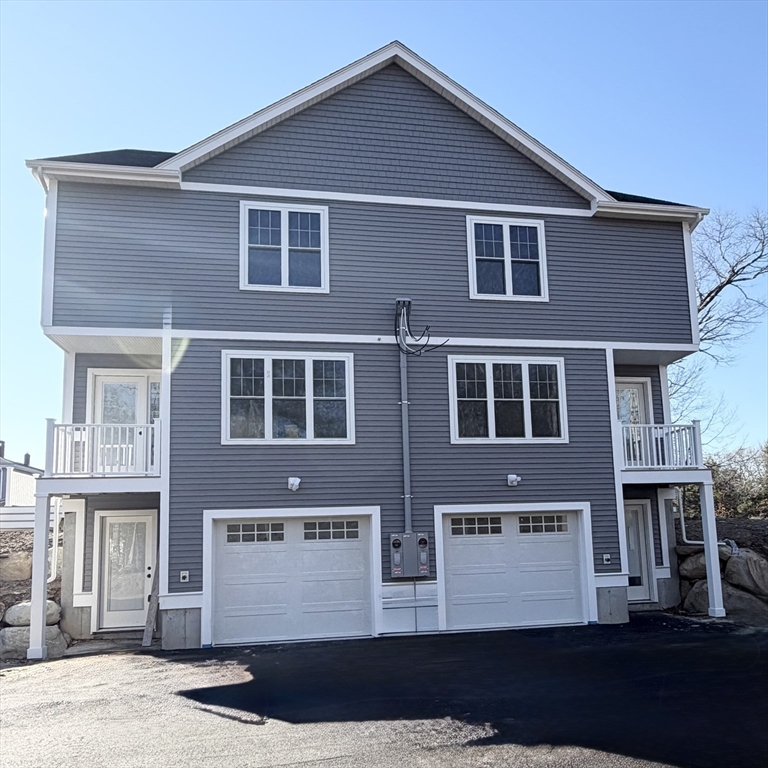 580 Broad Street, Unit 2 Bridgewater, MA 02324 - Photo 2 of 16 a front view of a house with a yard