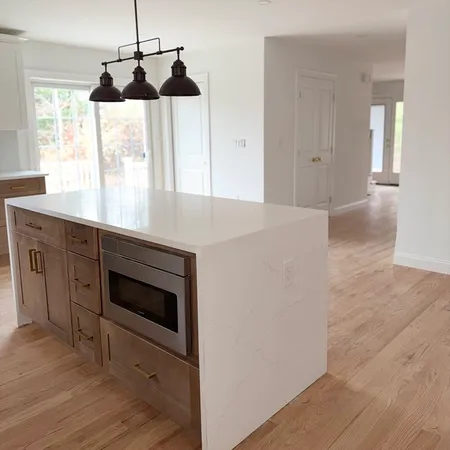 a kitchen with a stove and a wooden floor