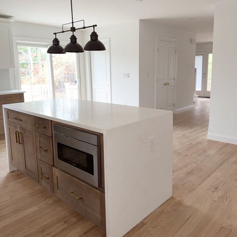 580 Broad Street, Unit 2 Bridgewater, MA 02324 - Photo 3 of 16 a kitchen with a stove and a wooden floor