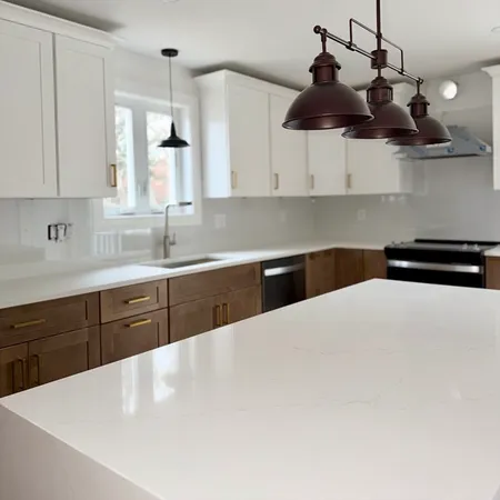 a kitchen with stainless steel appliances a sink a stove a refrigerator and cabinets