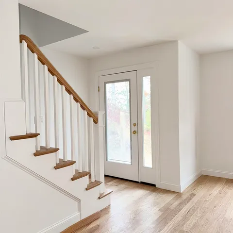 a view of staircase with white walls and railing